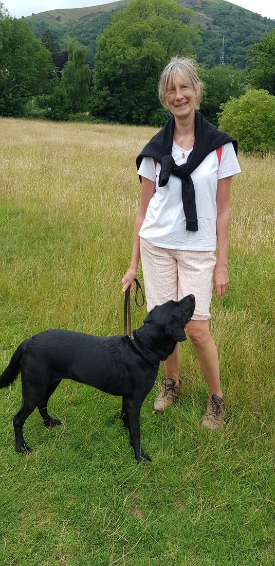 Dee and Jax, the dog, posing for a photo in front of the Malvern Hills