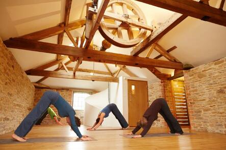Yoga class in a vaulted gym