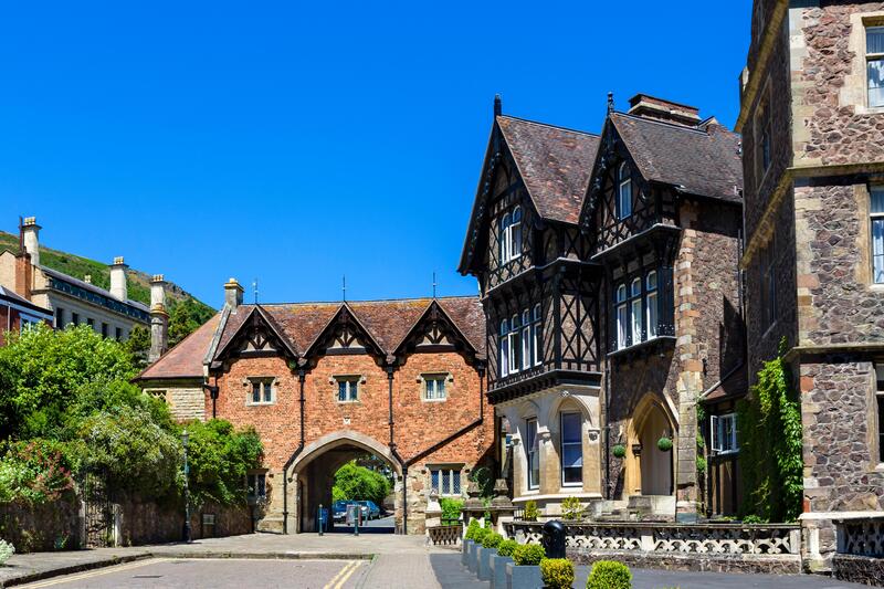The historic buildings of the Great Malvern Museum building with an archway tunnel and the Abbey Hotel.